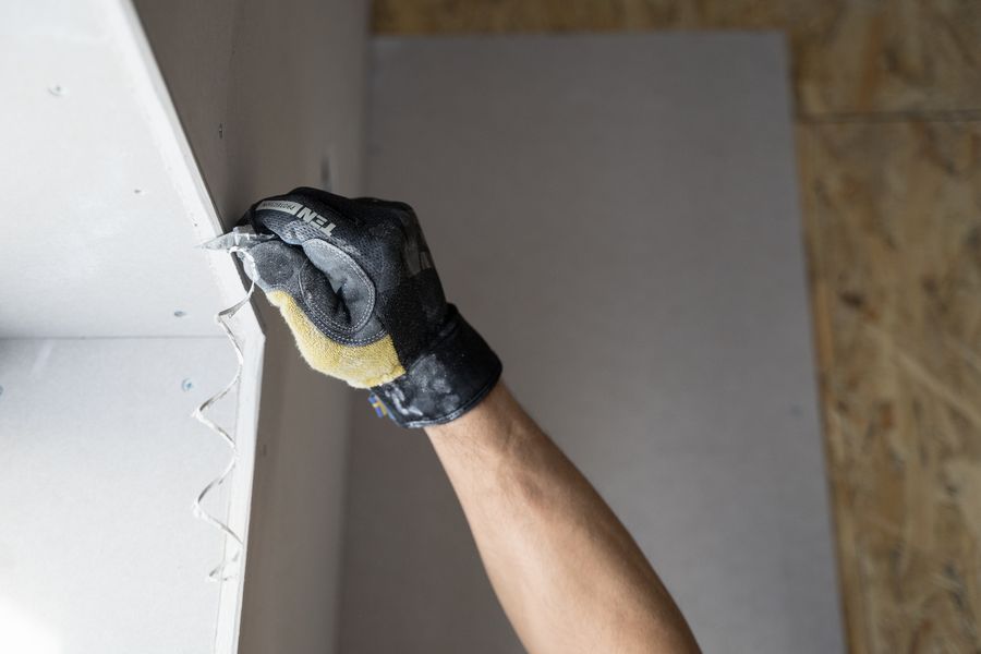Drywall compound being applied to a wall repair